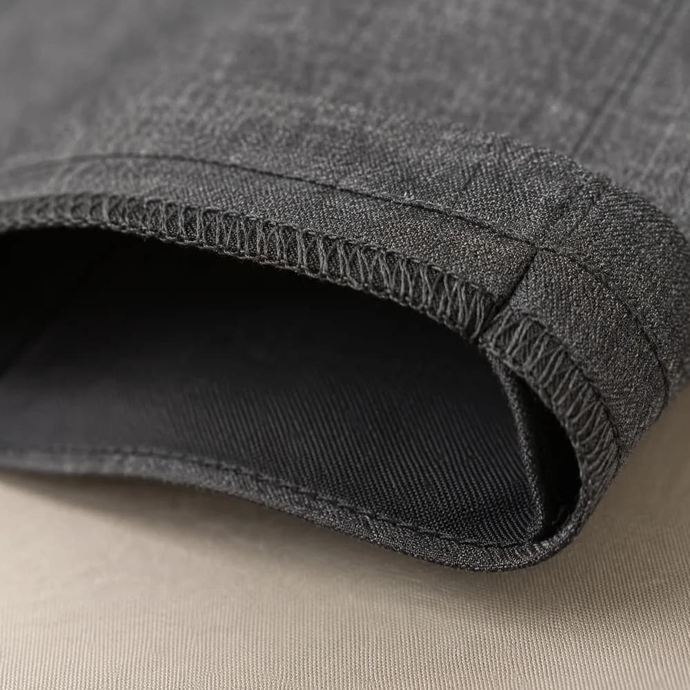 Close detail of a original hem on charcoal wool.