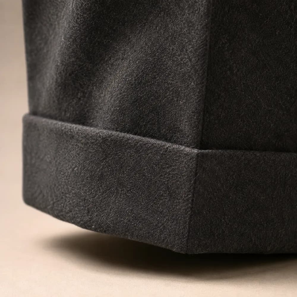 Close detail of a turn-up on charcoal wool.